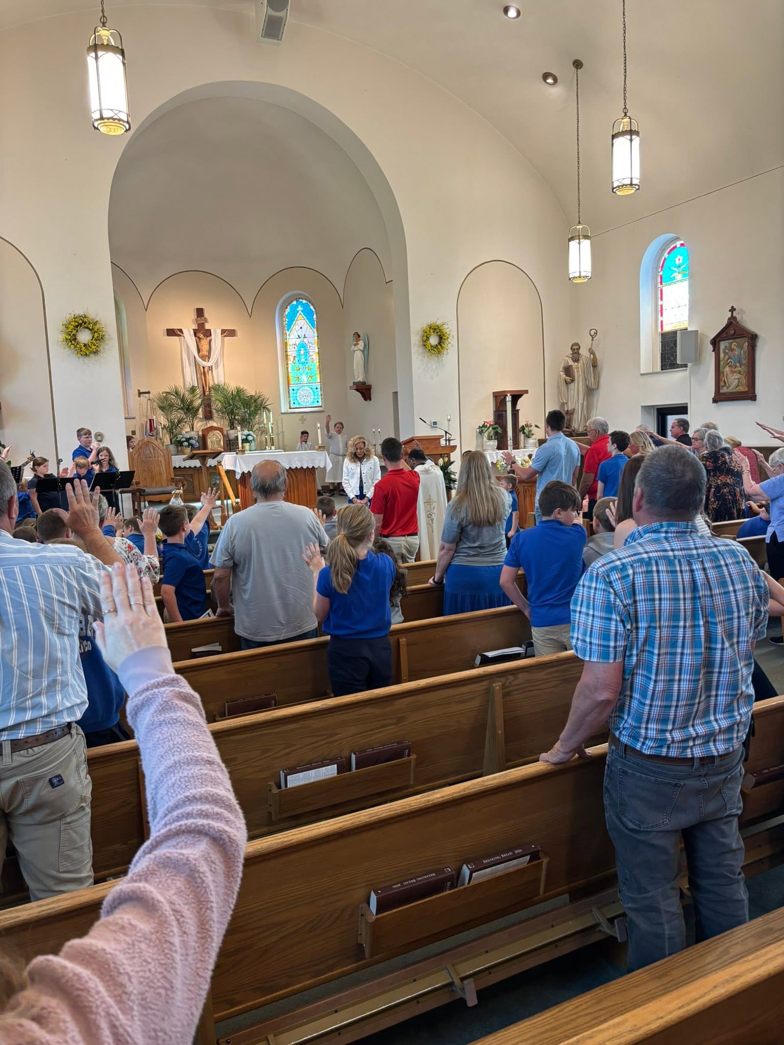 Students and families gather inside a church.
