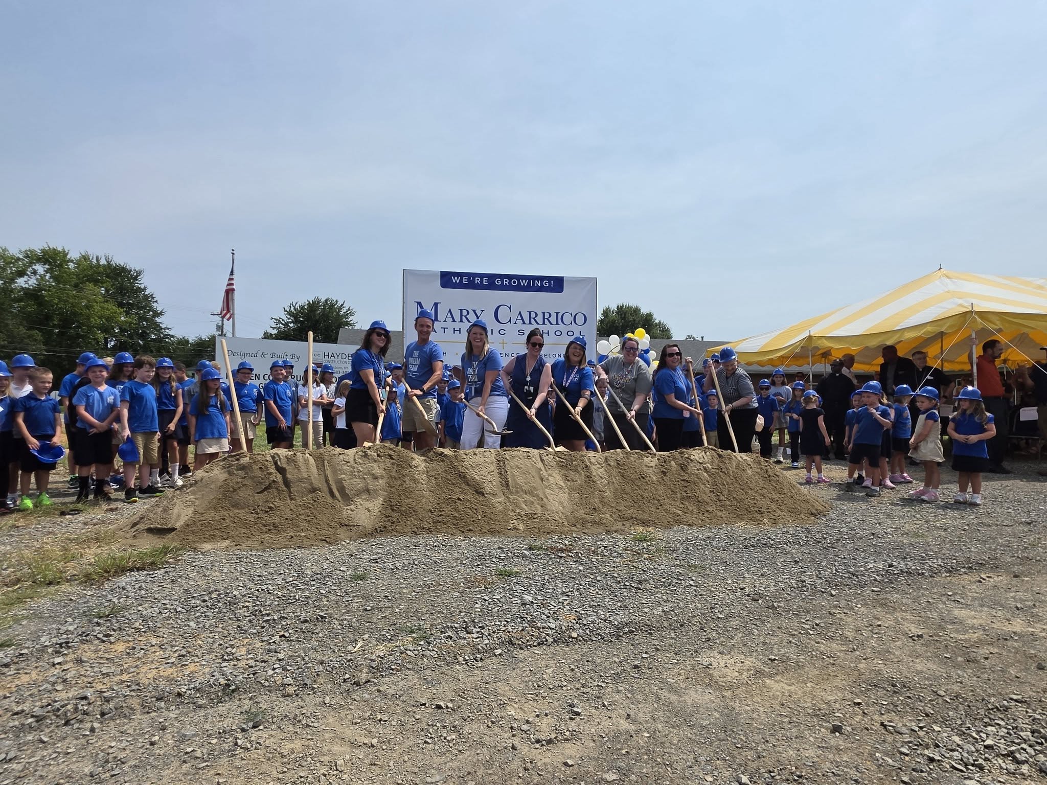 Mary Carrico students and school community members gather with shovels at the school expansion groundbreaking.
